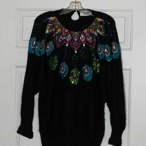 Black sequin beaded sweater and size L. 58% silk, 30% nylon, 10% angora.